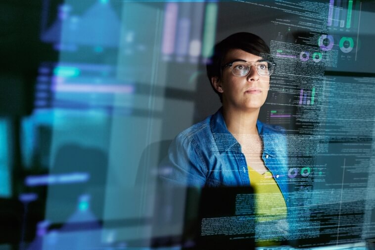 Engineer analyzing monitoring dashboards and metrics on screen